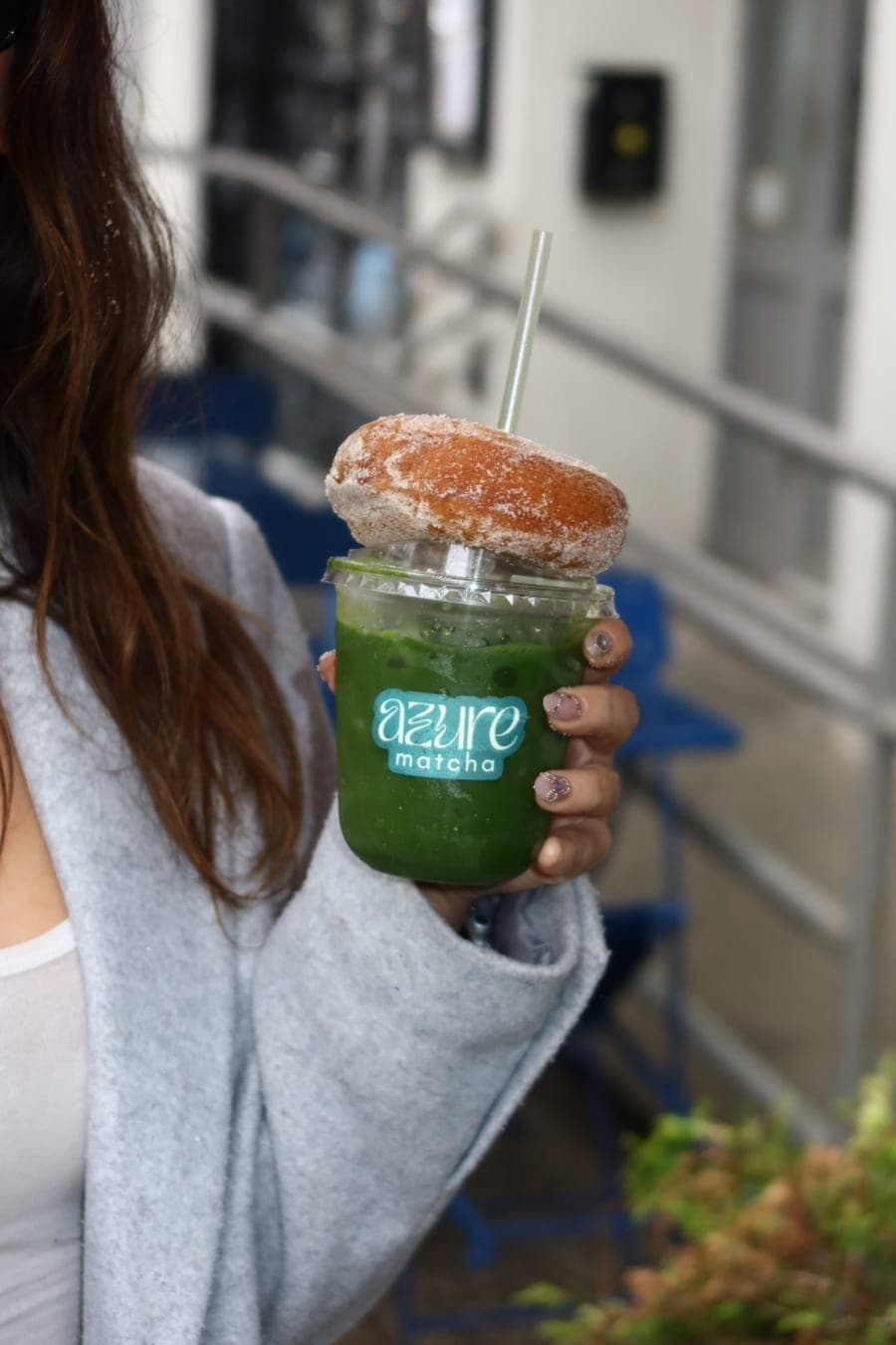 An iced Azure Matcha topped with a cinnamon sugar donut